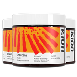 Three tubs of Kion Creatine Powder with orange-and-red labels and white lids, shown in a stacked product display.